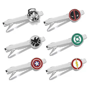 Close-up of silver necktie clips featuring superhero shield and comic character designs
