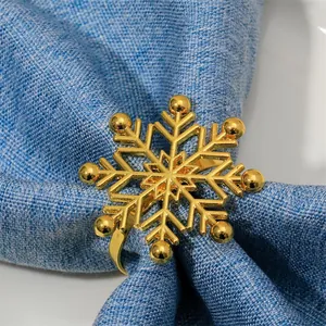 Golden snowflake napkin ring with polished metal finish for Christmas table decor