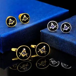 Macro detail of Masonic cufflinks and studs with blue G logo on black enamel and crystals