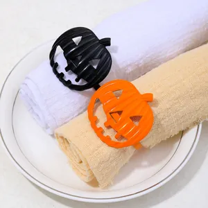 Detail of pumpkin napkin rings in black and orange for festive Halloween table decor