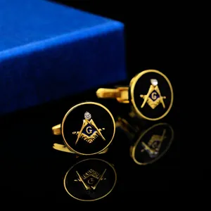 Detail of round Masonic cufflinks with black enamel, gold metal and a zircon stone