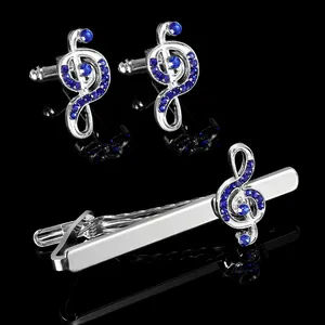 Polished silver tie clip and cufflinks set with blue crystal musical note design