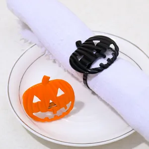 Halloween pumpkin napkin rings in orange and black enamel for festive table decoration