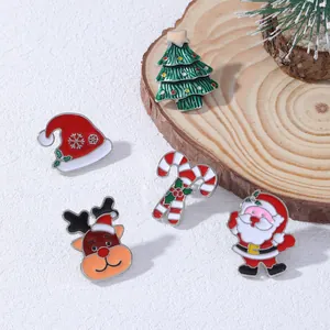 Set of 5 Christmas enamel brooches featuring Santa, tree, and reindeer on white background