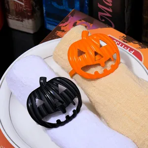 Close-up of orange and black pumpkin napkin rings used for Halloween table decor