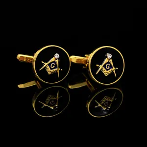 Macro view of gold Freemasonry cufflinks with black enamel inlay and sparkling crystal