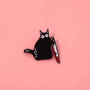 Macro detail of quirky black cat enamel pin with knife and sharp metal texture