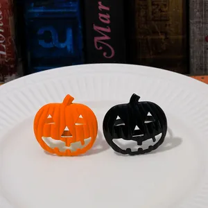Detailed view of orange and black pumpkin napkin rings for Halloween table decor