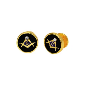 Macro shot of gold-plated Freemason cufflinks with black enamel and sparkling crystal
