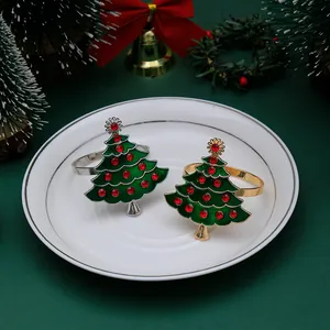 Close-up of green Christmas tree napkin rings with red rhinestones and metallic base