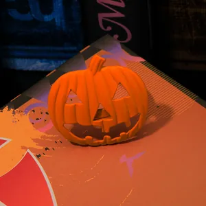 Detailed view of orange metal pumpkin napkin ring with a Jack-o'-lantern carved face