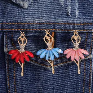 Three ballet dancer brooches with rhinestones and petals pinned on denim jacket pocket