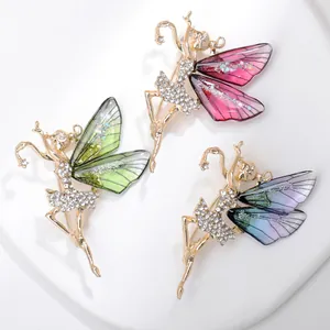 Detailed close-up of ballerina pins with rhinestones and colorful enamel wings