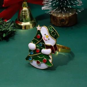 Christmas snowman napkin ring with tree and rhinestones on green decorative setting