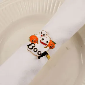 Detail of Halloween napkin ring with ghost pumpkin charms on a white ceramic plate