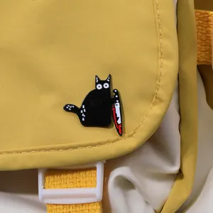 Creative black cat enamel pin badge holding a knife on a canvas bag accessory