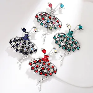 Close-up of four ballet dancer brooches with colorful rhinestones on a white plate