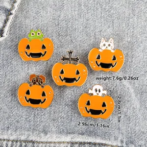 Detail of Halloween enamel pins with pumpkin base and cartoon animals on denim background