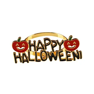 Golden Halloween napkin ring with Happy Halloween text and smiling pumpkin charms