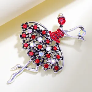 Close-up of ballet dancer brooch with red rhinestones and vintage silver finish
