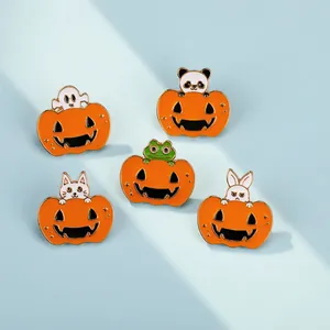 Close-up of Halloween enamel pins featuring pumpkin designs with cartoon ghosts and animals