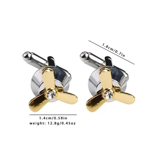 Macro detail of airplane propeller cufflinks with crystal stud and silver-gold finish