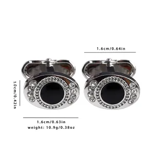 Macro shot of silver-colored oval cufflinks featuring black stone and crystal accents
