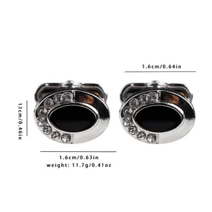 Detailed view of silver oval cufflinks with black enamel inlay and crystal border