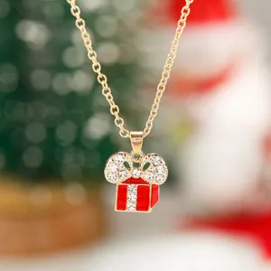 Dettaglio di una collana a pacchetto regalo di Natale in oro con smalto e strass