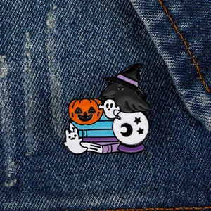 Detail of Halloween enamel pin with black crow, orange pumpkin lantern and white ghosts