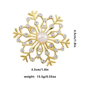 Detail view of snowflake brooch with gold plating, pearls, and crystals showing 4.5cm size
