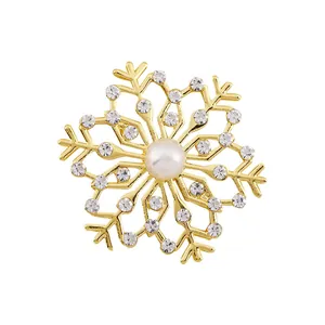 Elegant gold snowflake brooch with pearls and rhinestones for winter fashion style
