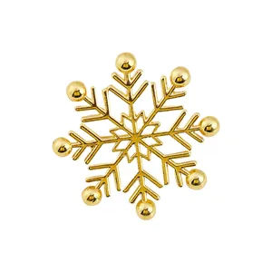 Detailed view of intricate gold snowflake brooch with delicate geometric hollow design