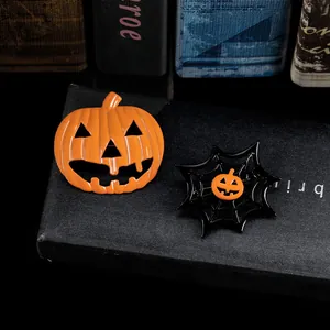 Detail view of Halloween Jack-o'-lantern and spider web pins on black gift box background