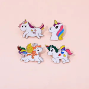 Detail view of four cute enamel unicorn pins with vibrant colors and gold metallic edges