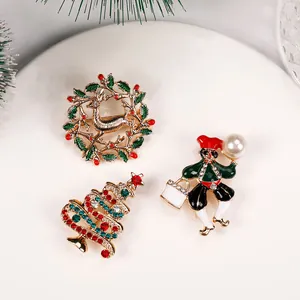 Detailed view of three festive Christmas brooches including reindeer wreath and xmas tree