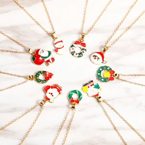 Detailed set of nine Christmas necklaces with colorful festive pendants on a marble surface