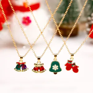 Macro view of festive enamel Christmas charms including bells and gloves on gold chains
