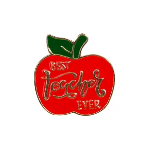 Detail shot of red apple enamel brooch pin with Best Teacher Ever gold engraving