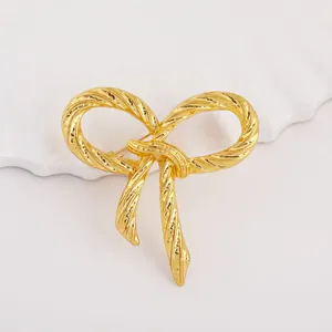 70s style vintage bowknot brooch in gold finish with textured twist rope metal design