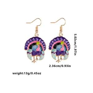 Colorful turkey drop earrings with gold plating and dimensions shown on white background