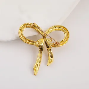 70s vintage-style golden textured bow brooch with needle pin back for women