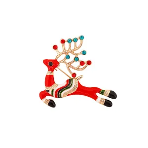 Detail shot of a festive red enamel reindeer brooch with colorful rhinestones and gold plating