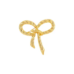 70s style textured gold bow brooch with twisted metal design for women outfits