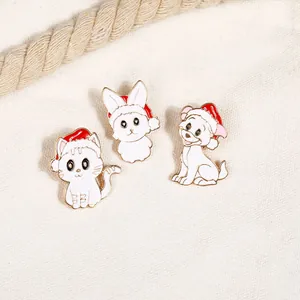 Detailed macro view of three cute enamel animal pins featuring a cat, rabbit, and dog in Xmas hats