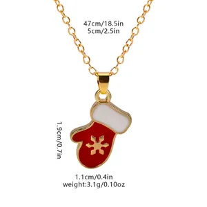 Detail showing red Christmas stocking pendant necklace with golden snowflake engraving