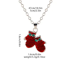 Detailed view of red Christmas mitten pendants with green bows on a metal chain