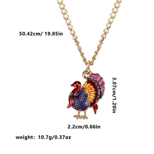 Golden turkey pendant necklace with colorful enamel detailing and size measurements