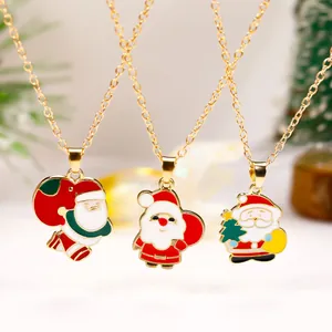 Three festive gold Santa Claus necklaces with colorful enamel pendants on o-chains