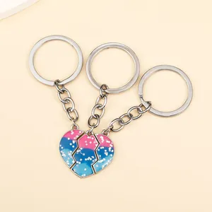 Detailed view of three-piece heart-shaped puzzle keychains with pink and blue glitter finish